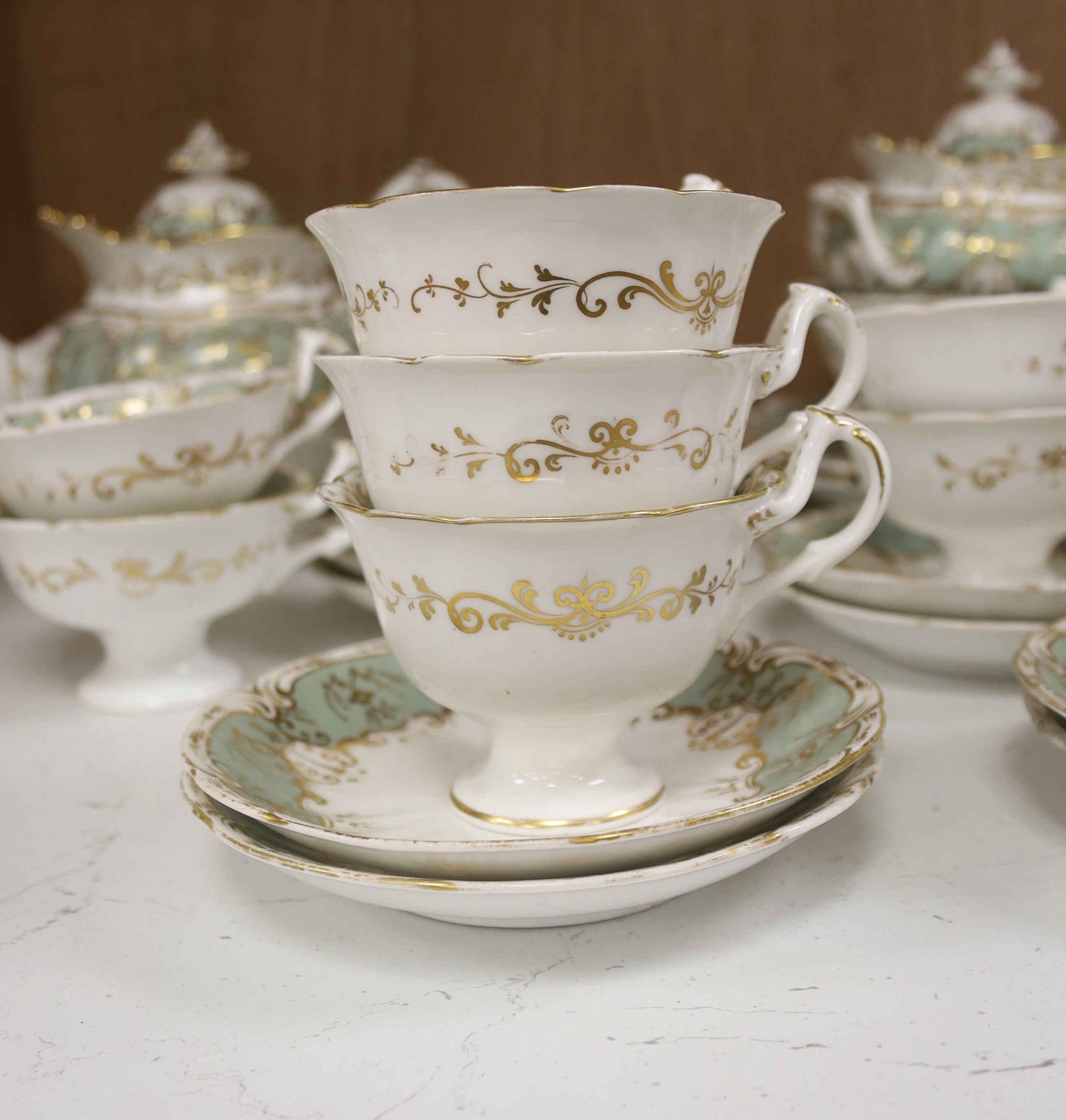 An English porcelain eau-de-nil gilt decorated tea service, c.1840